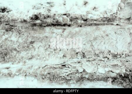 Tracce di diversi pneumatici per auto sulla neve sporca. Sfondo astratto, tessitura Foto Stock