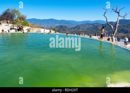 I turisti in un lago di fatto dalle cascate pietrificate, Hierve el Agua, Oaxaca, Messico Foto Stock