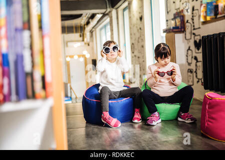 Piacevole soleggiato azienda bambini divertenti occhiali da sole brillante Foto Stock