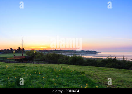 Alba cielo di Ramsgate visto da Pegwell Bay della Nave Vichinga. Blu cielo con sottile fascia di colore arancione sull'orizzonte. Chalk cliffs e sulla baia con la bassa marea. Foto Stock