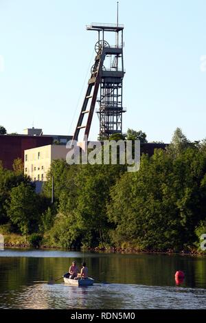 Canotto sul fiume Ruhr in Essen-Ueberruhr, albero in disuso tower Schacht Heinrich dell'ex miniera di carbone Heinrich, Essen Foto Stock