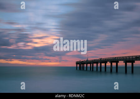 Una lunga esposizione al sunrise a St. Augustine Beach Pier, o St. Johns County Ocean Pier, in Sant'Agostino, Florida Foto Stock