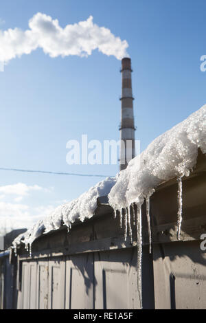 Soffiatura di fumo dal tubo di utilità a Kiev sulla gelida giornata invernale, come età sovietica il sistema di riscaldamento centrale richiede un grande volume di olio combustibile e carbone o gas nat Foto Stock