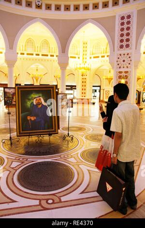 Mostra di pittura con le immagini della famiglia reale di Dubai e Suk dorato nel centro commerciale di Dubai, Dubai, Emirati Arabi Uniti Foto Stock