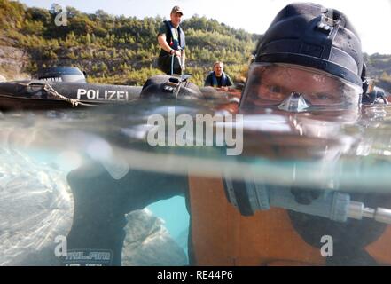 La polizia subacquei facendo una ricerca in un lago Foto Stock