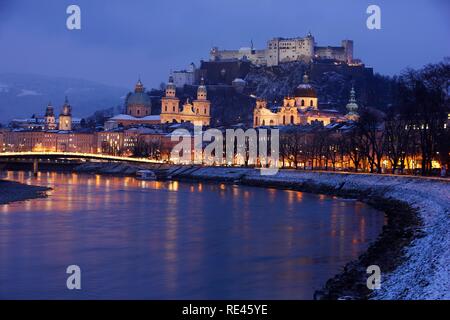 Città vecchia con Kollegienkirche chiesa, la Salzburger cattedrale Dom e il Festung fortezza di Hohensalzburg, il fiume Salzach, di notte Foto Stock