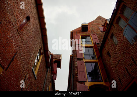 Groningen, Paesi Bassi: ristrutturato edifici medievali in Europa, verniciato con colore rosso brillante e rifiniture gialle. Nord del museo di spedizione. Foto Stock