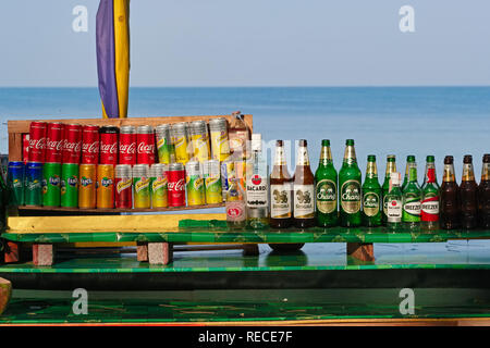 Le lattine di Coca Cola, altre bevande analcoliche e birra le bottiglie a una pressione di stallo sulla spiaggia, su una mattina presto a Bang Tao () Bangtao Beach, Bang Tao, Phuket, Tailandia Foto Stock