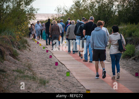 Le persone sono godendo bella serata nel parco, camminando sulle scale verso il tramonto. Percorso di candela sulla Terra. Cattura del momento. Foto Stock