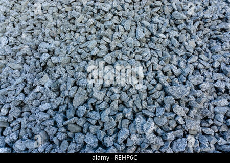 Grigio pietra di massa sullo sfondo di macerie di molte piccole pietre Foto Stock