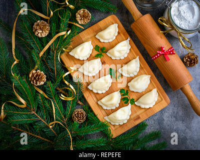 Gnocchi di natale con decorazione su un cartone grigio. Vista dall'alto. Foto Stock