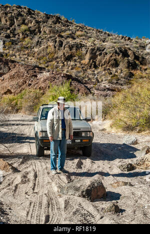 Traveler guardando il blocco di roccia jeep strada in tre Dike area collinare in Bofecillos montagne, deserto del Chihuahuan, Big Bend Ranch State Park, Texas, Stati Uniti d'America Foto Stock