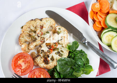 Cavolfiore arrosto di manzo servita con Spinaci appassito e pomodoro grigliate Foto Stock