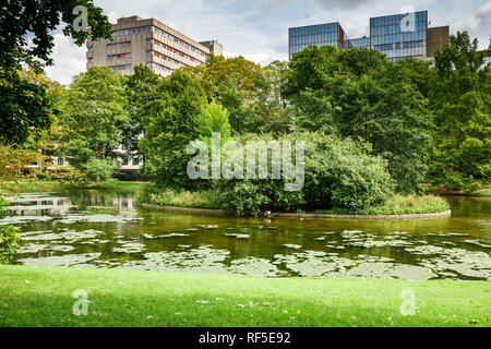 Parco Leopold con stagno, alberi ed edifici a Bruxelles, in Belgio. Foto Stock