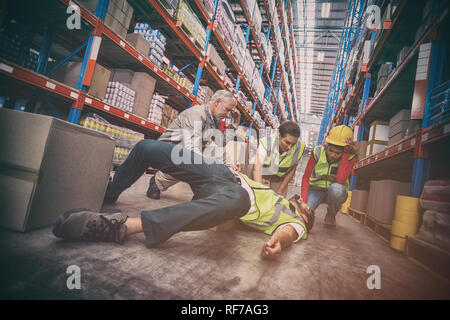 Lavoratore caduto durante il trasporto di scatole di cartone Foto Stock