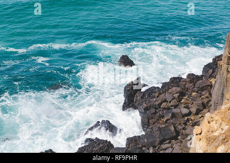 Sole che splende in giù su spruzzi d'acqua Foto Stock