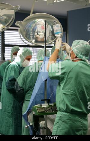 Sala operatoria , assistente di anestesia cambiando la sacca di infusione Foto Stock