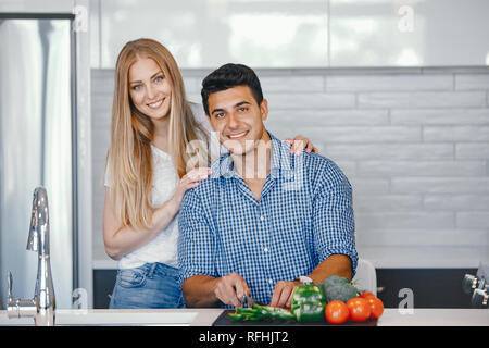 Uomo in camicia blu che taglia e taglia cipolla og tagliere di legno, con  altre verdure sullo sfondo Foto stock - Alamy