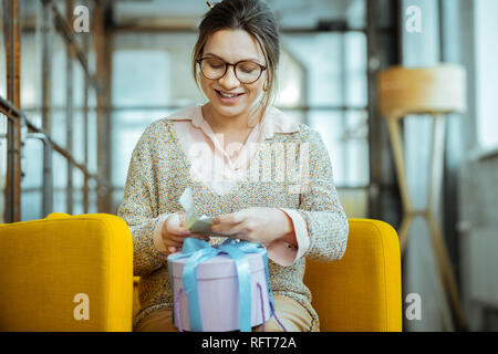 Moglie sensazione molto felice dopo aver presente dal marito Foto Stock