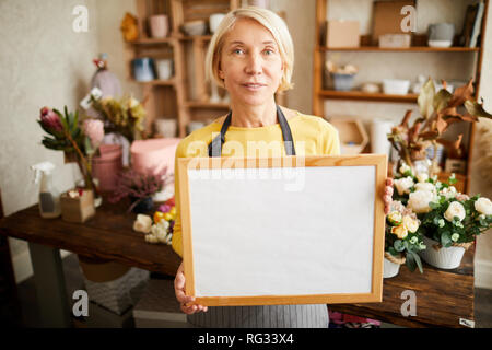 Fioraio Holding firmano Foto Stock