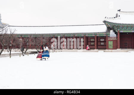 Il palazzo Gyeongbokgung in inverno e le ragazze in abiti Hanbok. Foto Stock