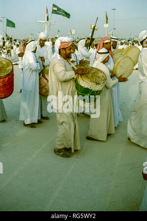 Dubai. Arab festeggiamenti nuziali con gli uomini nel tradizionale abito araba generalmente si diverte, canto, danza, sfilano in Emirato di Dubai in 1986 Foto Stock