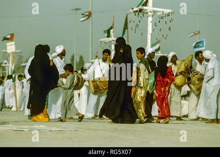 Dubai. Arab festeggiamenti nuziali con gli uomini nel tradizionale abito araba generalmente si diverte, canto, danza, sfilano in Emirato di Dubai in 1986 Foto Stock