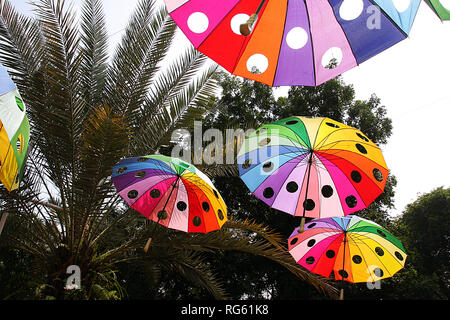 Multi-ombrelloni colorati appesi in un parco, Indonesia Foto Stock