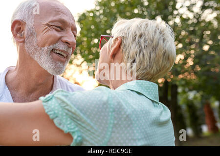 Felice coppia senior abbracciando all'aperto Foto Stock