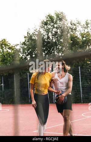 Coppia giovane divertirsi sul basket Foto Stock