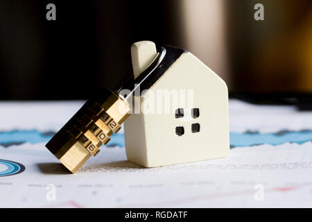 Piccola casa con serratura, protezione di sicurezza degli asset Foto Stock