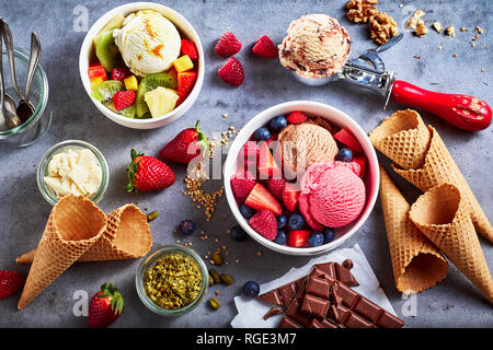 Frutta fresca con palline di Specialità crema gelato di gusti assortiti con lampone, Berry, mirtillo, fragola, noce , il pistacchio, cioccolato Foto Stock