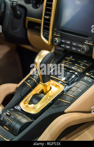 Moderne auto di lusso all'interno.golden ingranaggio automatico stick shift. Foto Stock
