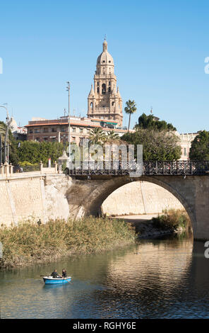 Matura in barca a remi sul fiume Segura con la cattedrale di Murcia in background, Spagna, Europa Foto Stock