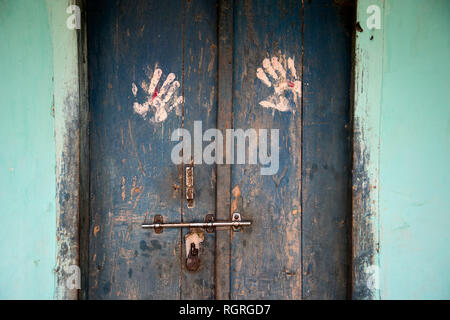 India. Bihar . Katari Middle Village. Handprints bianco su una porta blu. Foto Stock