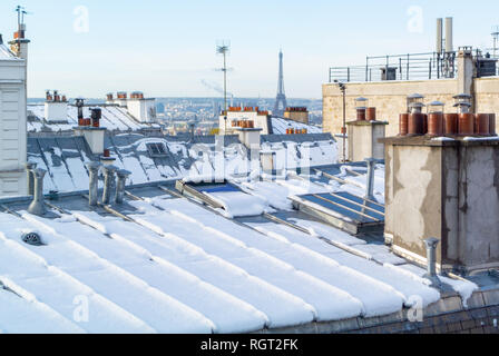 Tetti coperti di neve con la vista della Torre Eiffel, Parigi, Francia Foto Stock