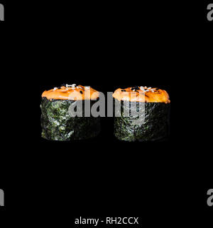 Sushi. Sfornati con salmone, isolato in sfondo nero Foto Stock