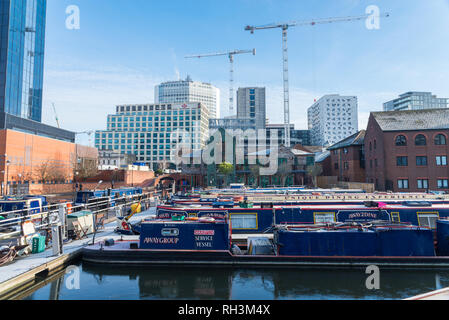 Colorate imbarcazioni strette ormeggiata su un canale congelati al Regency Wharf, Gas Street Basin in Birmingham Foto Stock