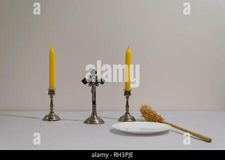 Croce, candele e preparati degli sprinkler prima di sacerdote visitazione. Foto Stock