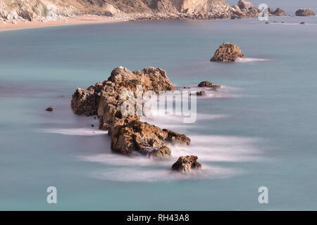 Una lunga esposizione del mare intorno a un ripiano di rocce a Durdel porta in Dorset Foto Stock