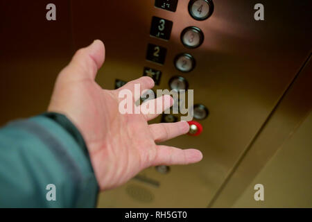 Persona della mano che mostra la frustrazione e la paura mentre bloccati su un malfunzionamento di ascensore. Foto Stock