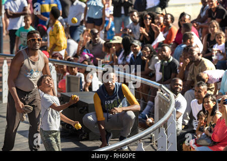 Cape Town, Sud Africa - Gennaio 2th, 2019: A sud di un ragazzo africano giocoleria con sfere all'anfiteatro di V & A whaft, Cape Town. Foto Stock