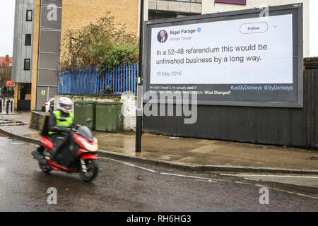 Londra, UK, 1 feb 2019. Uno scooter passa un cartellone vicino all'Arsenal nel nord di Londra, mostrando un preventivo da Nigel Farage dal 2016. Una chiamata di gruppo se stessi "Led da asini' crowdfunding sono una campagna denominata "Let's incollare queste tweet in tutta la Gran Bretagna', affitto i cartelloni pubblicitari in tutto il paese per mostrare le citazioni e i tweet di Brexit relative promesse da parte di politici e altre dichiarazioni di eminenti Brexiteers. Credito: Imageplotter News e sport/Alamy Live News Foto Stock