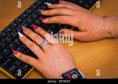 Signora con chiodi colorati in ufficio Foto Stock