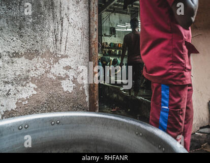 I giovani lavorano duro all'interno del dharavi slum in Mumbai India Foto Stock