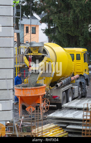 Neuwied, Germania - 1 Febbraio 2019: un trucker è in attesa fino a quando i flussi mortale da un mortaio transporter in un silo di cemento Foto Stock