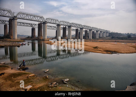 Dhobi visto lavare le vesti sulla banca del fiume di Barakar nella parte orientale dell India accanto a un ponte. Il Dhobi Ghat (lavaggio massa) di Kumardubi nella provincia Jharkhand è il più grande al mondo. Foto Stock