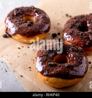 La pasticceria concetto. Le ciambelle con la glassa al cioccolato e biscotti al cioccolato/ Foto Stock