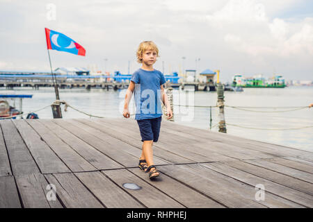 Ragazzo sul ponte di legno Clan Tan Jetty di George Town, Penang Foto Stock