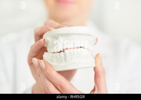 Close-up di dentista tenendo le dentiere in cliniche Foto Stock